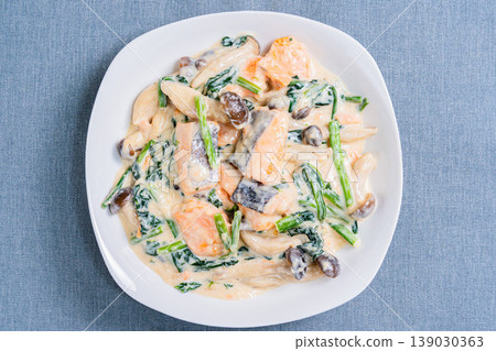 Creamy salmon and spinach dish with mushrooms in a rich white sauce. Creamy salmon and spinach dish with mushrooms in a rich white sauce. 139030363