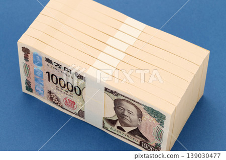 A stack of one million yen bills standing upright A stack of one million yen bills standing upright 139030477