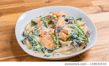 Creamy salmon and spinach dish with mushrooms in a rich white sauce. Creamy salmon and spinach dish with mushrooms in a rich white sauce. 139030534