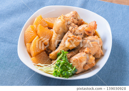 Braised chicken wings and daikon radish - a traditional Japanese home-style dish. Braised chicken wings and daikon radish - a traditional Japanese home-style dish. 139030928