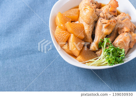 Braised chicken wings and daikon radish - a traditional Japanese home-style dish. Braised chicken wings and daikon radish - a traditional Japanese home-style dish. 139030930