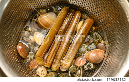 Razor clams and other shellfish caught in a net 139032182