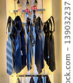 Yogyakarta, Indonesia - March 18th 2026: Collection of stylish neckties in shades of blue, grey, and black, neatly displayed on a store rack under warm lighting 139032237