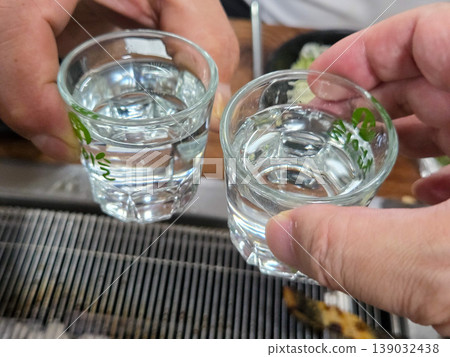 clear korean distilled spirit soju in a small glass 139032438