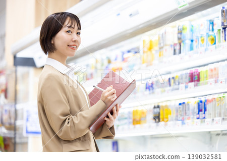 Female business professionals visiting supermarkets for store management training. 139032581