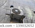 Summer heat countermeasures: Operating air conditioner outdoor unit and concrete wall 139032652