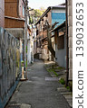 A streetscape of old houses lining a back alley in Japan. 139032653