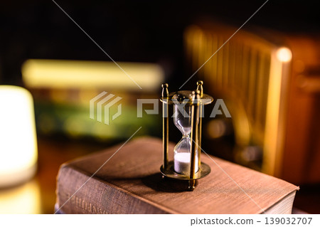 Hourglass and old books Hourglass and old books 139032707