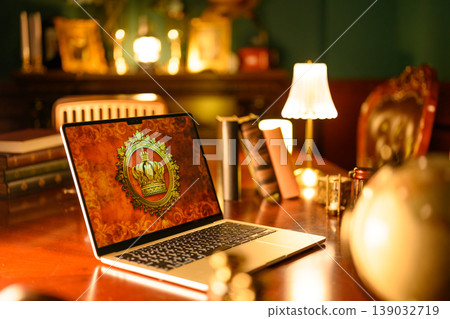 A laptop with a crown logo and a luxurious study. A laptop with a crown logo and a luxurious study. 139032719