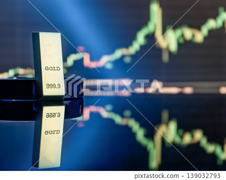 Pure gold bullion bar on a reflective surface with blurred financial trading charts background. Investment concept. Pure gold bullion bar on a reflective surface with blurred financial trading charts background. Investment concept. 139032793