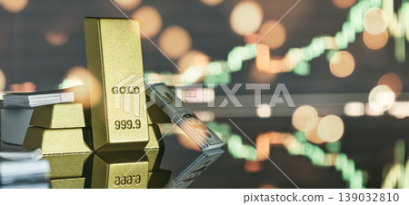 Physical gold bars and US dollar stacks on a reflective surface against a blurred rising stock market chart and bokeh. Investment concept. 139032810