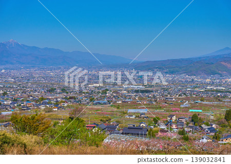 View from Fuefuki City, Yamanashi Prefecture in spring, looking northwest (Kofu Basin, Kofu City, Kai City, etc.) 139032841