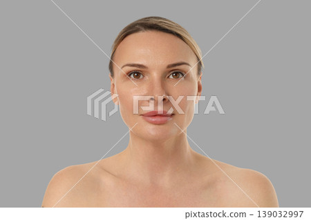 Model displays a healthy complexion and subtle makeup in a studio Model displays a healthy complexion and subtle makeup in a studio 139032997