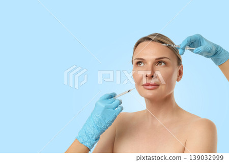 Patient enjoys cosmetic treatment in a calming setting Patient enjoys cosmetic treatment in a calming setting 139032999
