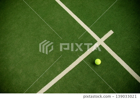 Padel ball rests on the court waiting for the match to start 139033021