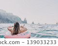 Woman, ocean, relaxing. Woman floats on pink donut ring in the sea enjoying summer vacation with copy space. 139033233