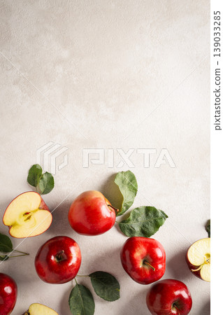 Red apples are arranged on a light surface with some cut in half Red apples are arranged on a light surface with some cut in half 139033285