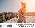 Woman in a Hat and Blanket Enjoying Mountain Views 139033318