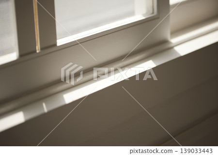 Natural Sunlight and Leaf Shadows on Window and Wooden Floor Background. 139033443