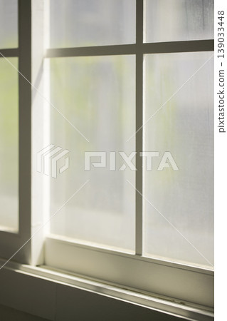 Natural Sunlight and Leaf Shadows on Window and Wooden Floor Background. 139033448