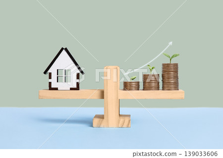House and stack of coins with young green seedlings on a wooden balance scale. Property investment and house mortgage financial real estate concept. Topics of saving, investing. House and stack of coins with young green seedlings on a wooden balance scale. Property investment and house mortgage financial real estate concept. Topics of saving, investing. 139033606