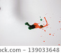 Green And Red Paints Blending Into Organic Shape Across White Background, Viscous Droplets And Delicate Trails 139033648