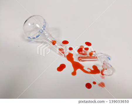 A shattered flask and spilled liquid suggest a science experiment gone wrong or a lab accident A shattered flask and spilled liquid suggest a science experiment gone wrong or a lab accident 139033650