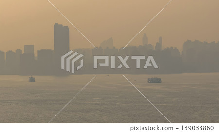 April 18 2026 Hung Hom Harbourfront Skyline In Golden Haze April 18 2026 Hung Hom Harbourfront Skyline In Golden Haze 139033860