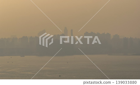 April 18 2026 Hung Hom Harbourfront Skyline In Golden Haze April 18 2026 Hung Hom Harbourfront Skyline In Golden Haze 139033880