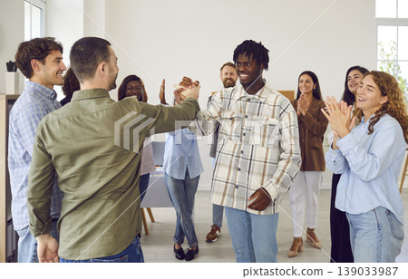 Smiling Diverse Group of Friends in a Circle Handshaking Smiling Diverse Group of Friends in a Circle Handshaking 139033987