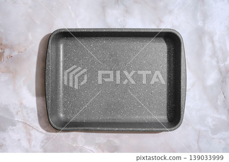 Baking tray placed on a marble surface ready for preparing food at home Baking tray placed on a marble surface ready for preparing food at home 139033999