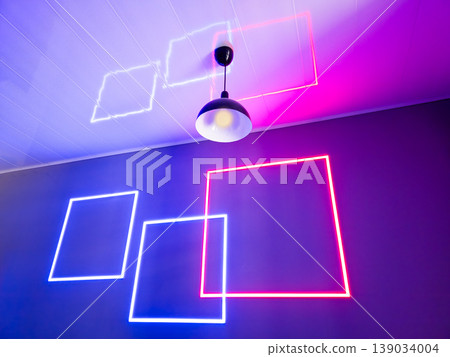 Neon light reflections create shapes on a ceiling in a room 139034004