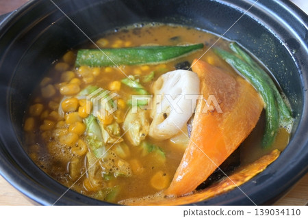 A piping hot soup curry with plenty of vegetables. A piping hot soup curry with plenty of vegetables. 139034110