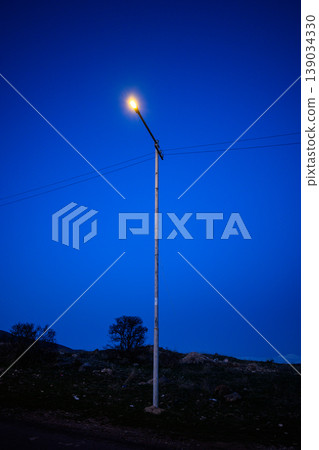 Night streetlight standing tall against deep blue dusk sky Night streetlight standing tall against deep blue dusk sky 139034330