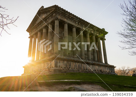 Sunlight highlights classical architecture on grassy hill Sunlight highlights classical architecture on grassy hill 139034359