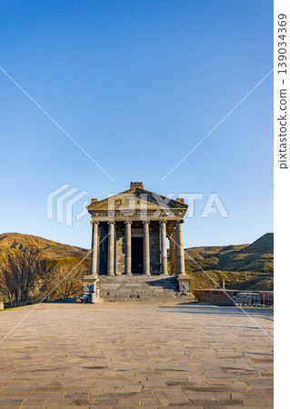 Stone temple with columns under sunny sky Stone temple with columns under sunny sky 139034369