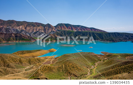 Stunning mountain lake with turquoise waters surrounded by layered Stunning mountain lake with turquoise waters surrounded by layered 139034435