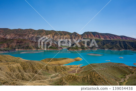 Serene mountain lake with vivid blue water Serene mountain lake with vivid blue water 139034438