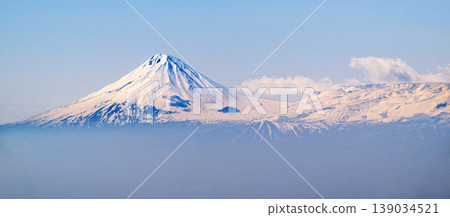 Misty morning view of snowy mountain peak 139034521