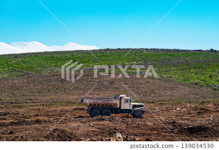 Vintage truck moves through a harvested field Vintage truck moves through a harvested field 139034530