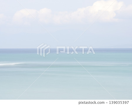 A calm sea in early summer, with a blue gradient background captured using a slow shutter speed. A calm sea in early summer, with a blue gradient background captured using a slow shutter speed. 139035397