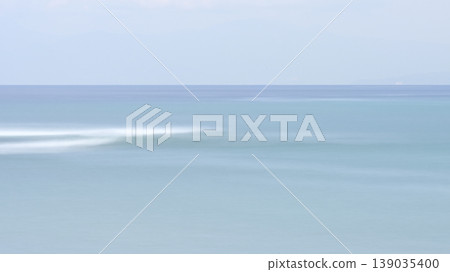 A calm sea in early summer, with a blue gradient background captured using a slow shutter speed. A calm sea in early summer, with a blue gradient background captured using a slow shutter speed. 139035400