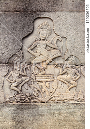Wall carving with two womans dancers apsara, famous Angkor Wat complex, Siem Reap, Cambodia. Stone texture and bas-relief with dancing girls. Topic of vacation, travel, trip, cruises, tour Wall carving with two womans dancers apsara, famous Angkor Wat complex, Siem Reap, Cambodia. Stone texture and bas-relief with dancing girls. Topic of vacation, travel, trip, cruises, tour 139036703