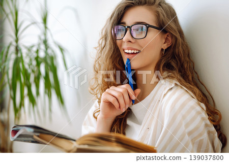Young woman writing notes. Business, blogging, freelance, education concept. Concept of comfort. 139037800