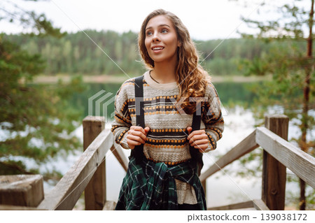Attractive young woman enjoying fresh air on the lake. Travel, Hiking, nature Attractive young woman enjoying fresh air on the lake. Travel, Hiking, nature 139038172