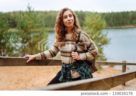 Attractive young woman enjoying fresh air on the lake. Travel, Hiking, nature 139038176