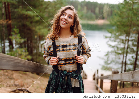 Attractive young woman enjoying fresh air on the lake. Travel, Hiking, nature Attractive young woman enjoying fresh air on the lake. Travel, Hiking, nature 139038182