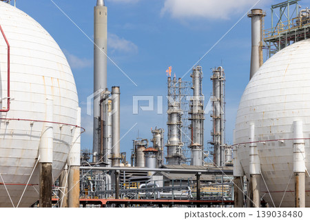 Industrial gas storage sphere tank at oil and gas refinery and petrochemical plant under blue sky, Oil and gas refinery plant and petrochemical industry infrastructure with gas storage tank pipeline. Industrial gas storage sphere tank at oil and gas refinery and petrochemical plant under blue sky, Oil and gas refinery plant and petrochemical industry infrastructure with gas storage tank pipeline. 139038480