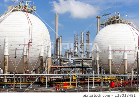 Industrial gas storage sphere tank at oil and gas refinery and petrochemical plant under blue sky, Oil and gas refinery plant and petrochemical industry infrastructure with gas storage tank pipeline. Industrial gas storage sphere tank at oil and gas refinery and petrochemical plant under blue sky, Oil and gas refinery plant and petrochemical industry infrastructure with gas storage tank pipeline. 139038481