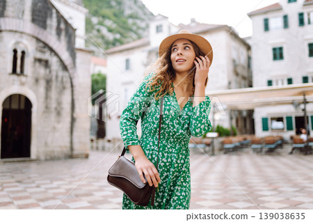 Happy woman walking in shopping street in Italy on vacation dressed in summer fashion dress. 139038635